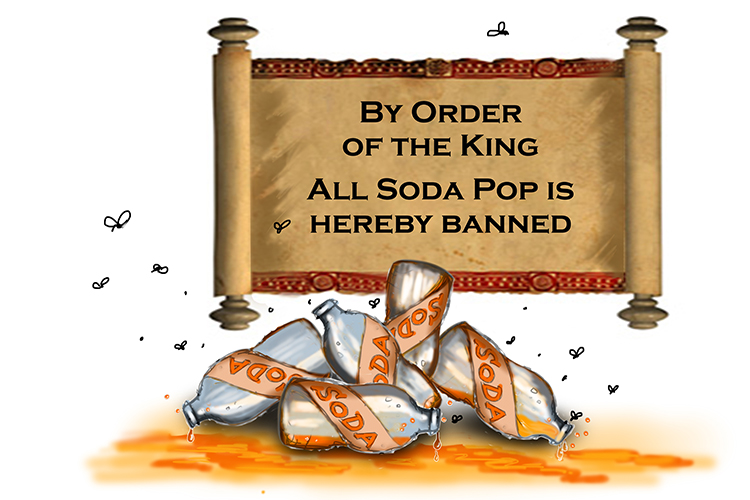 Empty soda bottles in front of a sign proclaiming the banning of soda